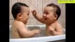 Twin babies laughing while taking bath