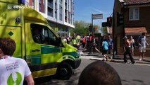 Ambulance rushes to help a runner during a half marathon in London on the hottest day of the year