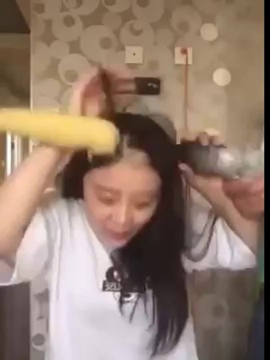 Asian Girl eating Corn with a drill fail