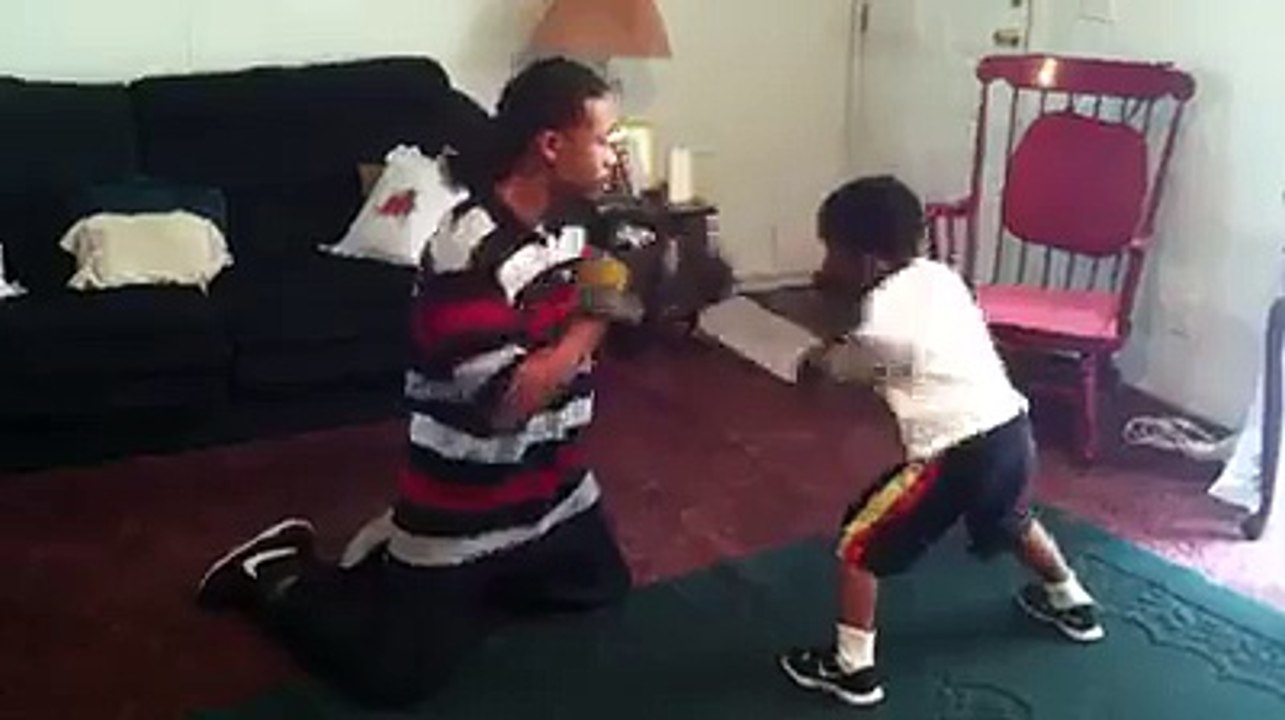 Boxer kid fighting with dad: