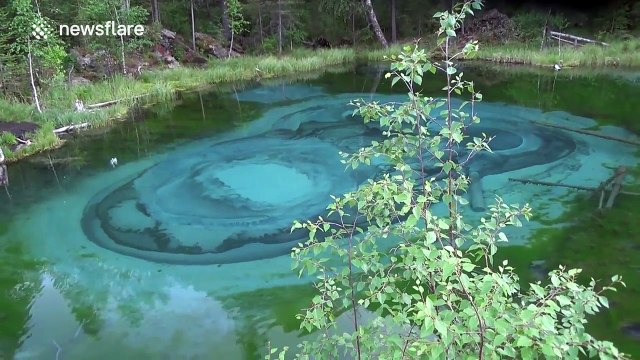 Stunning turquoise geyser lake in the Altai Mountains, Russia