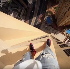 Man risks life jumping on the edge of a skyscraper