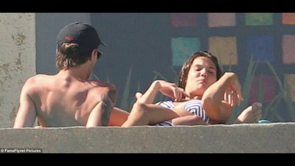 Shirtless Louis Tomlinson treats girlfriend Danielle Campbell to a romantic backrub in Cabo
