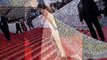 Amal Clooney struggles with her gown with George Clooney on the Cannes red carpet