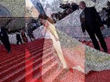 Amal Clooney struggles with her gown with George Clooney on the Cannes red carpet