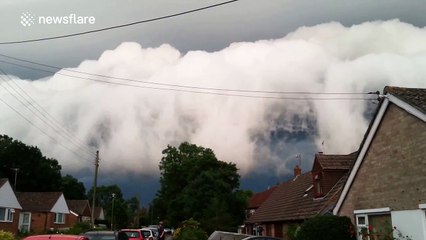 Bizarre storm clouds flow over English village
