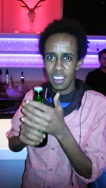 guy opens a beer with his teeths