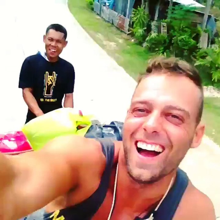 Guy travels on the roof of the bus in Philippines
