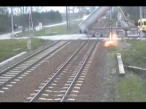 Truck tries to cross train tracks with its trailer up