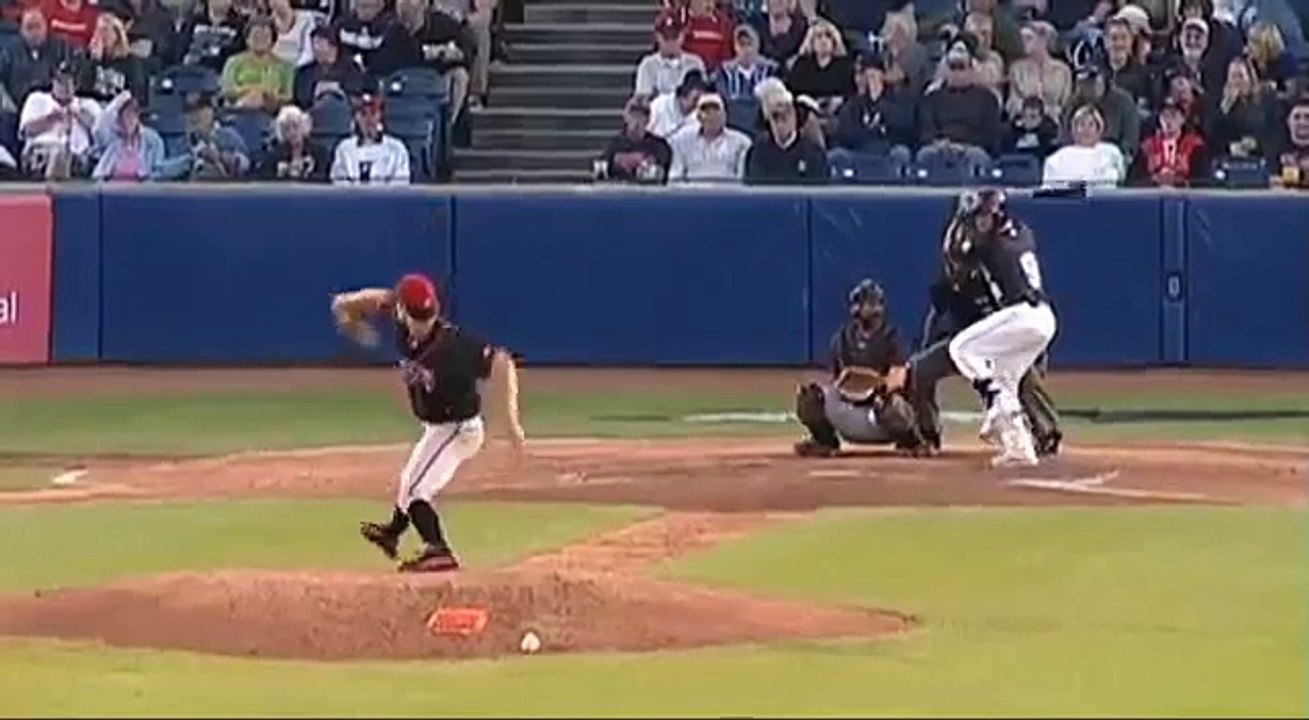 Pitcher saves face from hit.