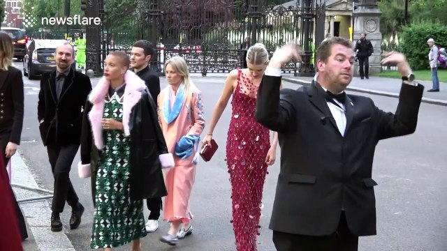 Model Lily Donaldson has trouble getting up stairs in long dress at British Vogue 100 Gala Dinner