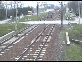 Truck tries to cross train tracks with its trailer up