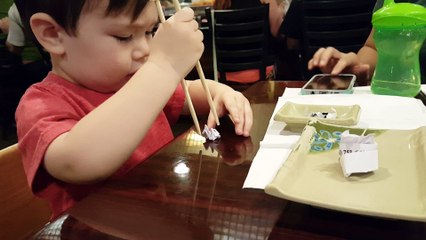Kid Learning to Use Chopsticks