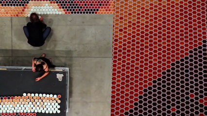 He positioned 66000 cups full of water. When the camera zooms out everyone is blown away.