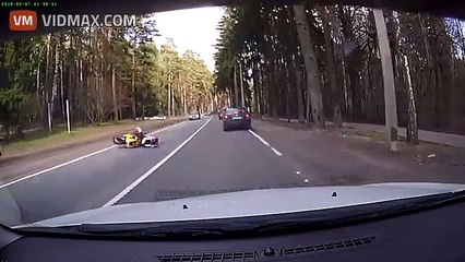 Man on motorcycle hit by runaway car tire on a Russian road