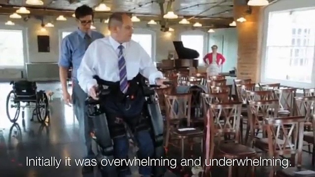 Paralysed man in bionic suit walks daughter down aisle - BBC News