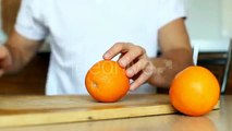 Man Cutting Orange On Chopping Board On White Background - Stock Footage | VideoHive 15317775