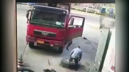 Shocking moment man is launched into the air as tyre explodes