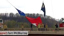 Firefighters raise flags to welcome back Fort McMurray residents