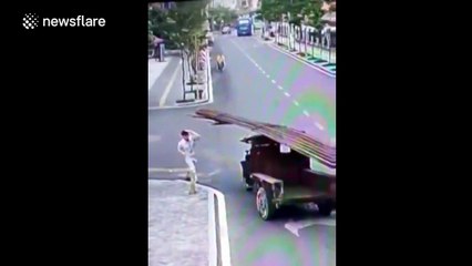 Cyclist taken out by falling lamp post