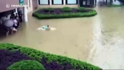 Student swims in floodwater in southeastern China
