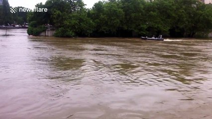 Man falls into the swollen River Seine, France