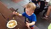 Epcot - Flower and Garden Festival - Little boy eats Bacon Cupcake