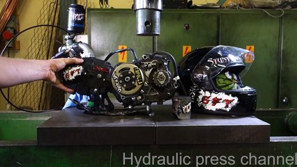 Crushing running 4-stroke motor and motorcycle helmet with hydraulic press