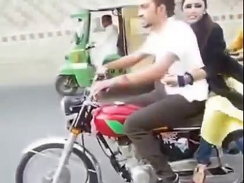 Pakistani Boy With A Girl Doing One Wheeling On Bike