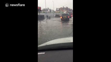 UK motorists battle through deep floodwater after heavy rainstorm