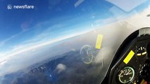 Glider soars above the clouds on a sunny day