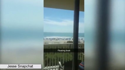 Tourist captures vessel floating above the horizon at Cocoa Beach, Florida.