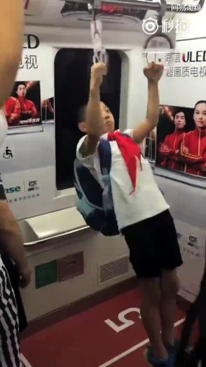 Boy Playing Gymnastics in Beijing Metro after School