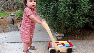 Maximilien - 1 year, 1 month, 26 days - Playing with the Max mobile with wooden shapes in Greece