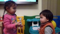 2 years old sister feeding her 11 months old brother