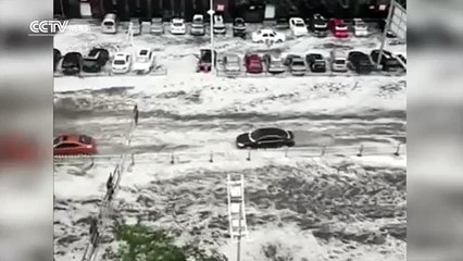 Footage Heavy rain and hail turn streets into rivers in NE China