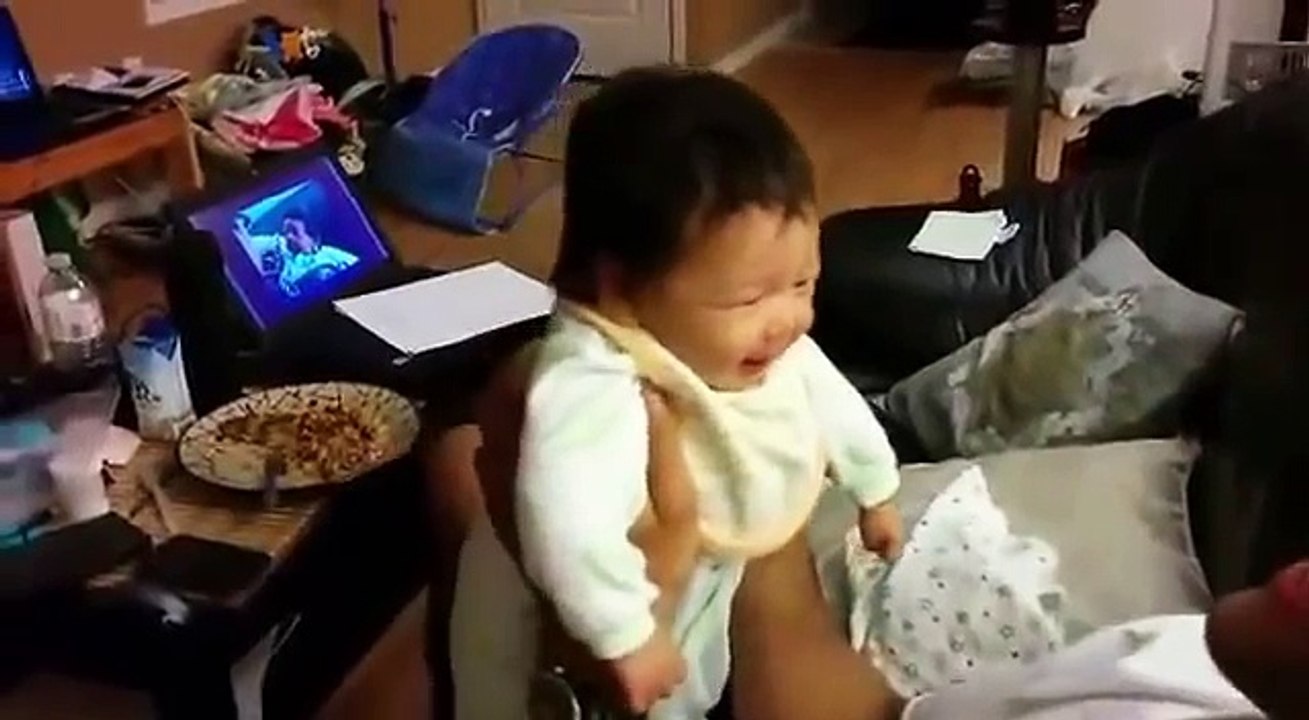 Le papa tient le bébé dans ses bras pendant que la maman filme, mais quand elle voit ça? Elle perd tous ses moyens!