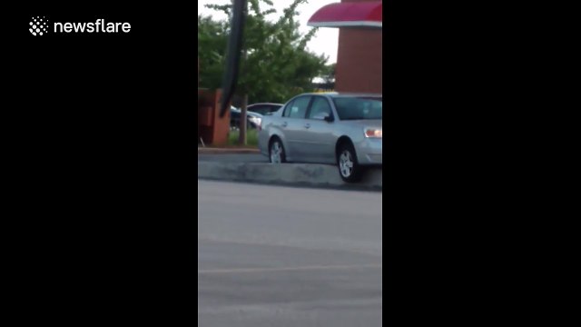 Car gets stuck on a drive-through ramp