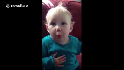 Baby's reactionto Cheerio is priceless