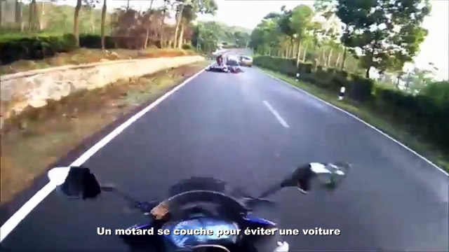 Sauvé de justesse se motard se couche pour éviter une voiture et un terrible accident