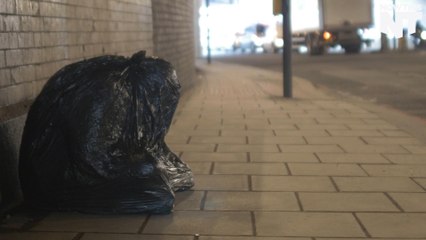 This Sculpture Shows A Homeless Person Wrapped In A Garbage Bag