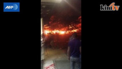 Buildings ablaze from blast at shopping district in Baghdad