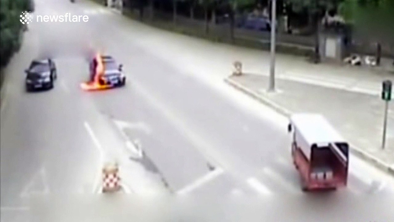 Car stopped at red light bursts into flames
