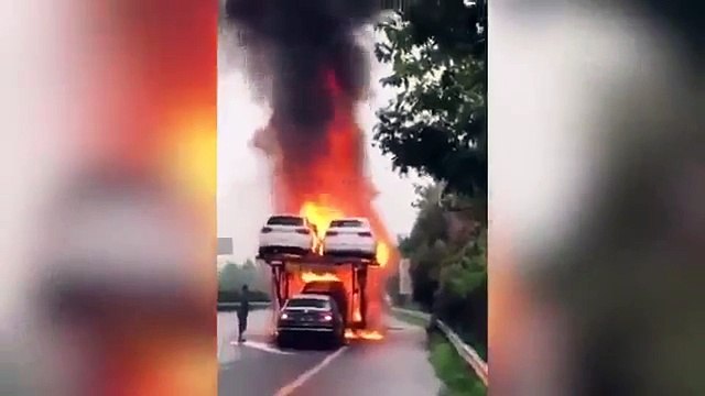 Real Life Fast & Furious Fearless truck driver reverses new car off his blazing transporter