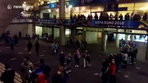 French supporters cheer and clap as Icelandic fans leave stadium