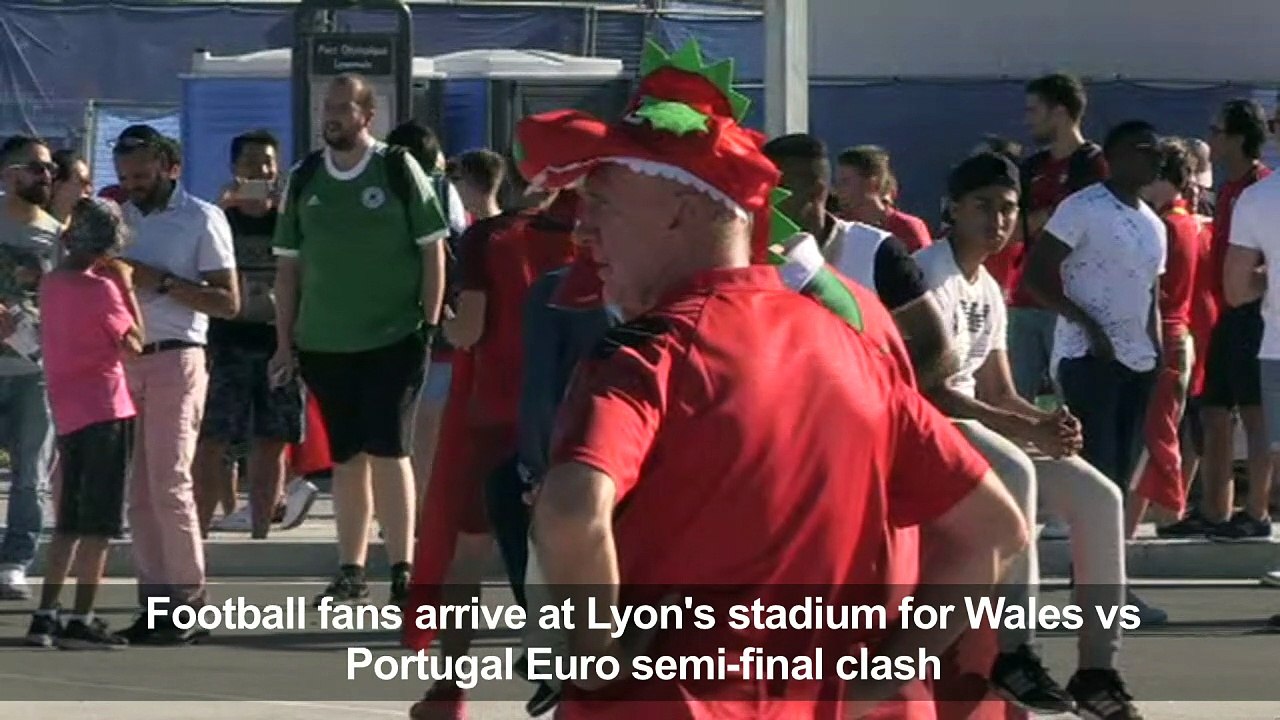 Football fans arrive at Lyon's stadium for Wale...