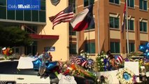 People leave flowers at memorial for slain officers