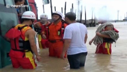 Firefighters rescue 50 bus passengers trapped by flood