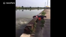 Motorcycle starts by itself and pushes fisherman into water
