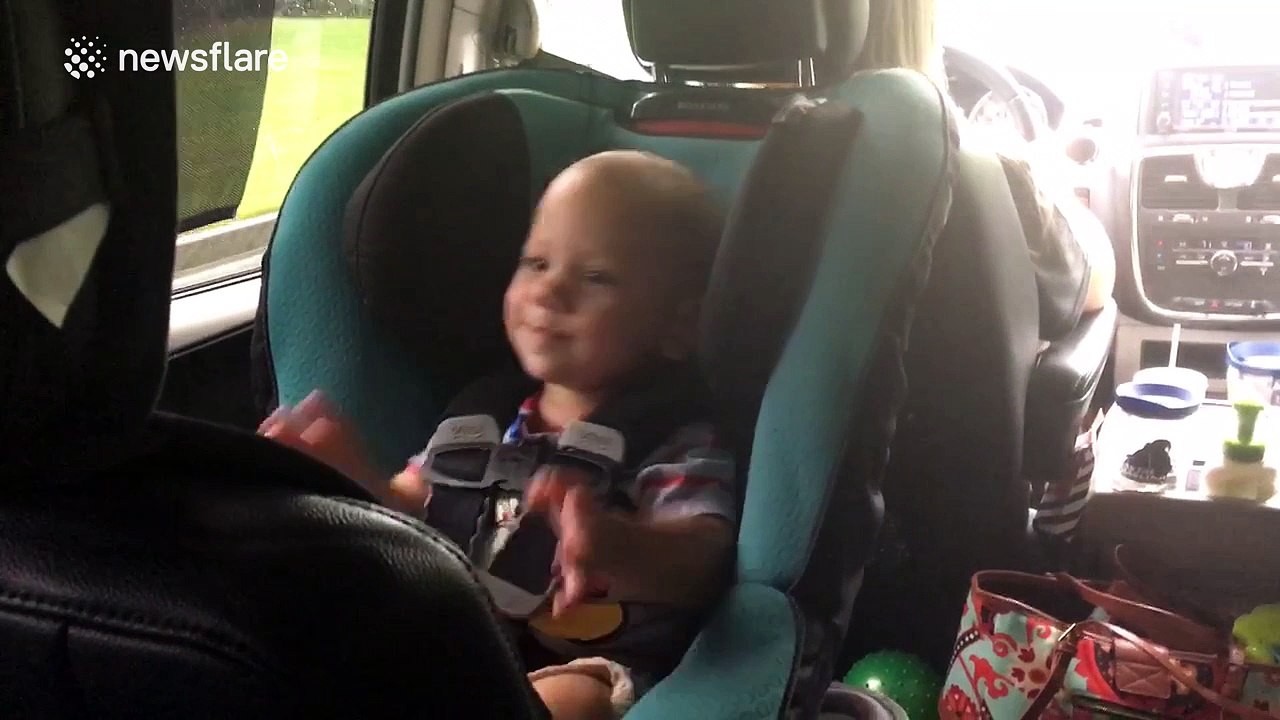 Twin babies dance to rock music during car trip